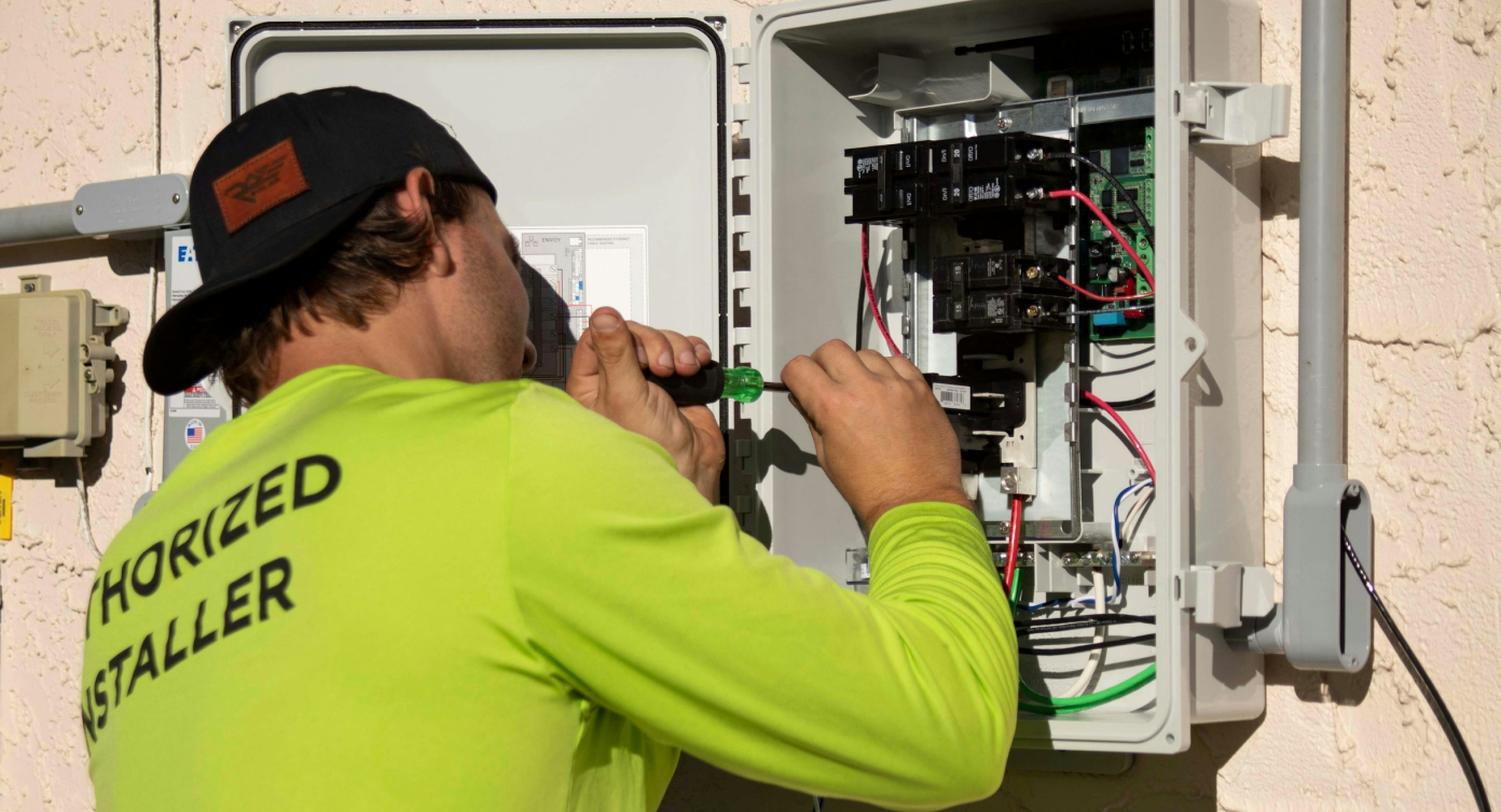 Electrical technician working on a breaker panel image